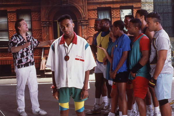 Publicity still from the film Do the Right Thing depicting a group of young men confronting an older man on the street.